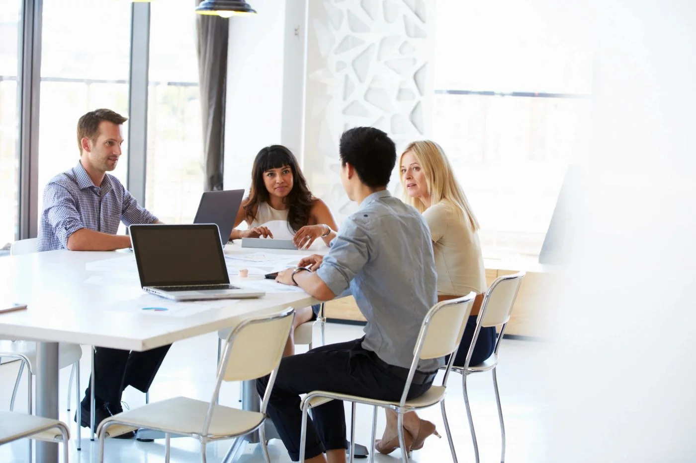 Colleagues sharing ideas around a meeting table